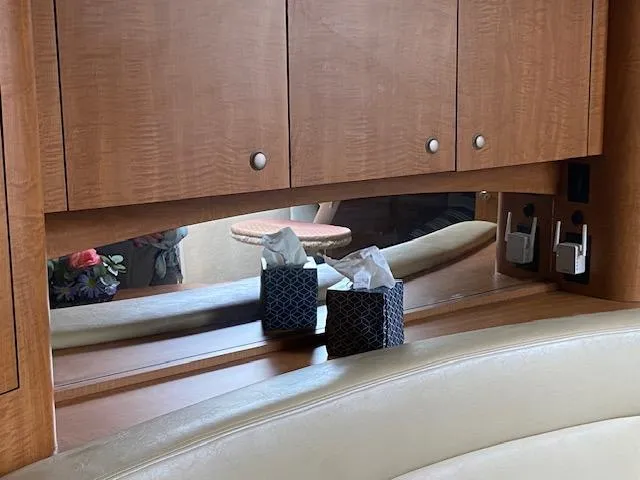 Slide: The Image of Interior of 2006 Sea Ray Sundancer with wooden cabinets and tissue boxes. - 8