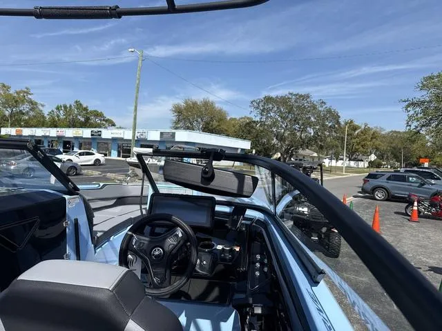 Slide: The Image of 2025 Yamaha Boats 255XD interior, sleek design, spacious seating, advanced controls, powder blue accents. - 10