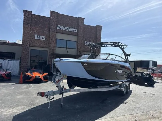 Slide: The Image of 2025 Yamaha Boats 255XD in powder blue with a black canopy, showcasing sleek seating. - 3