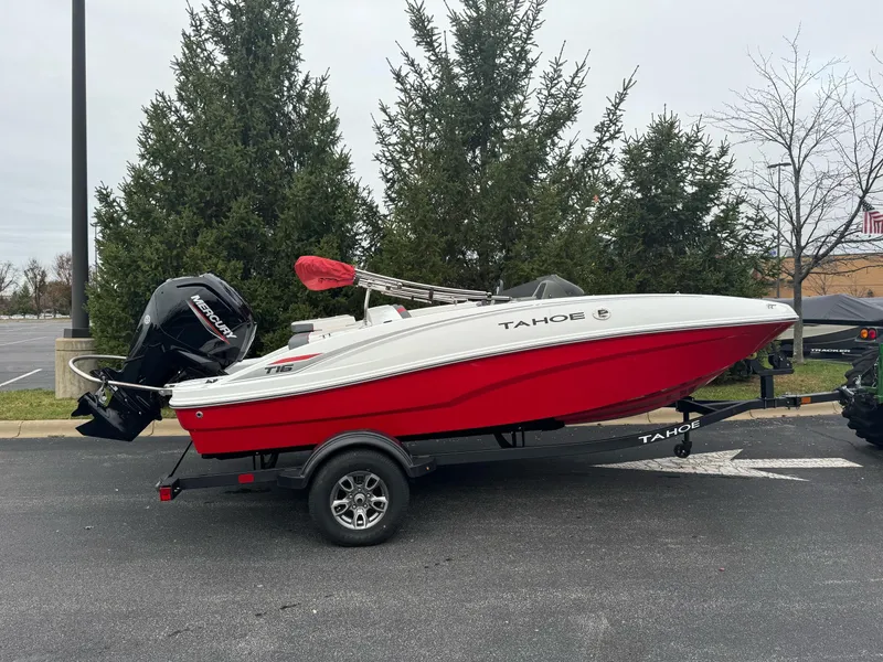 Slide: The Image of 2025 Tahoe T16 boat on trailer, red and white design, parked outdoors. - 0