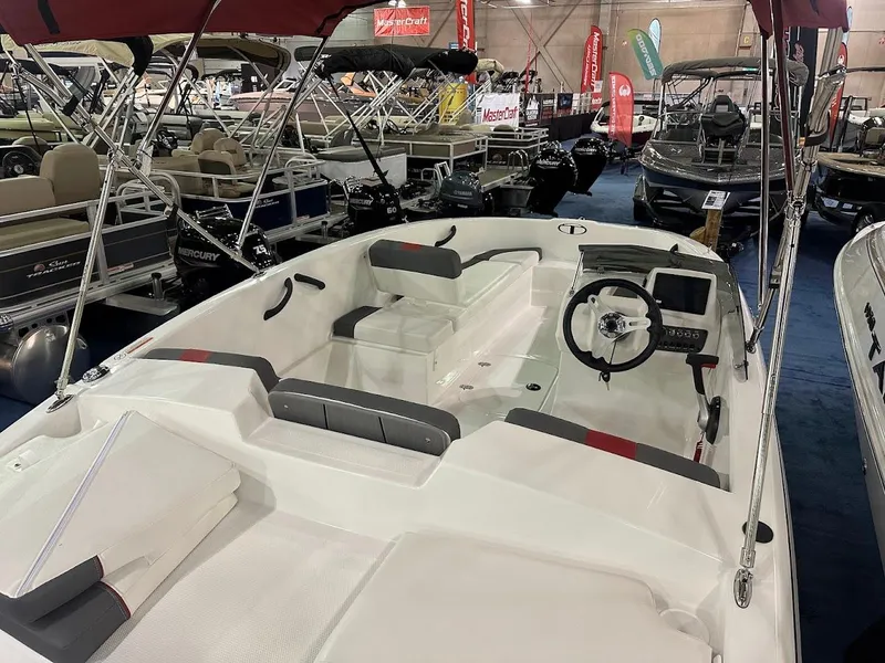 Slide: The Image of 2025 Tahoe T16 boat interior at a showroom, featuring seating and steering console. - 5