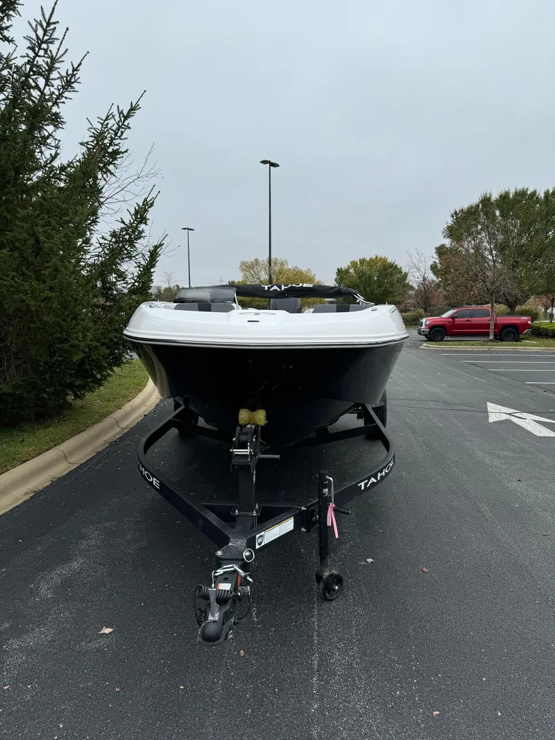 Slide: The Image of 2025 Tahoe T18 boat on trailer in parking lot. - 2