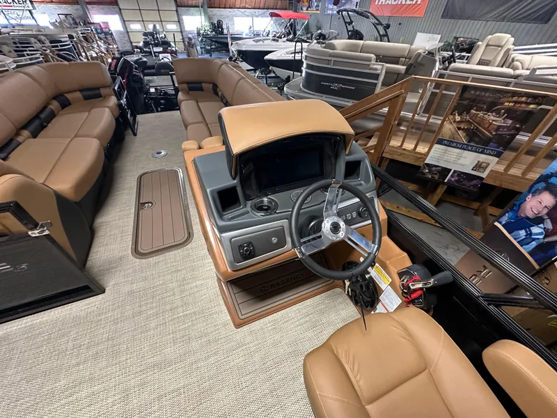 Slide: The Image of 2025 Regency 250 LE3 Sport boat interior with tan seating and modern dashboard. - 10