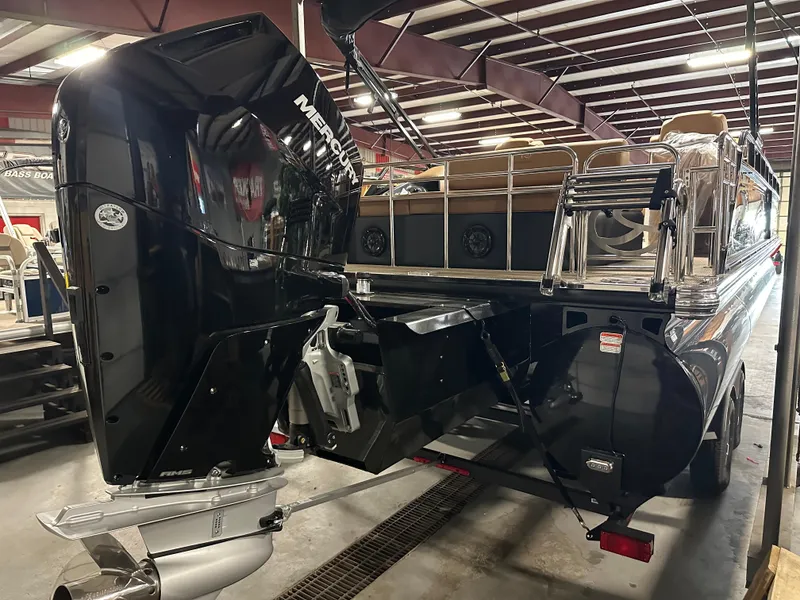 Slide: The Image of 2025 Regency 250 LE3 Sport pontoon boat with powerful Mercury outboard engine in a warehouse. - 13