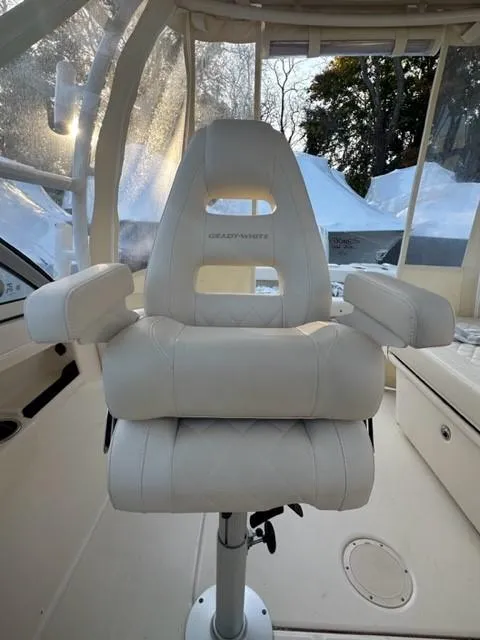 Slide: The Image of Captain's chair on 2024 Grady-White 255 FREEDOM boat, featuring plush white upholstery. - 10