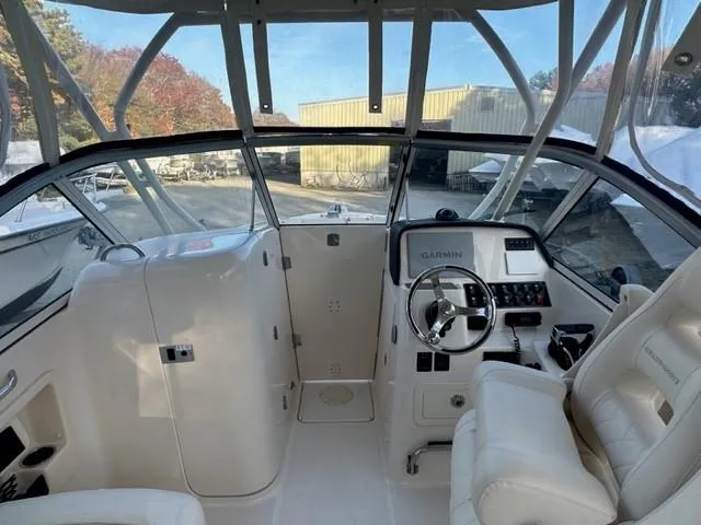 Slide: The Image of 2024 Grady-White 255 FREEDOM boat interior with steering wheel and seating. - 11