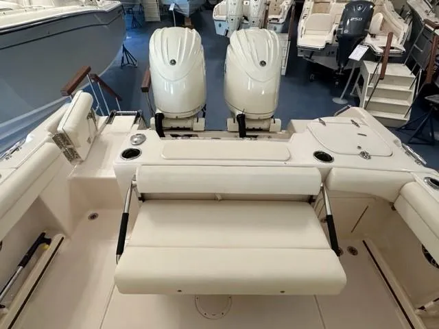 Slide: The Image of 2024 Grady-White 255 FREEDOM boat interior with dual engines and seating. - 18