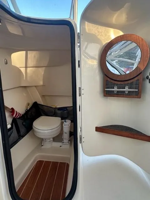 Slide: The Image of 2024 Grady-White 255 FREEDOM boat interior with toilet and mirror. - 25