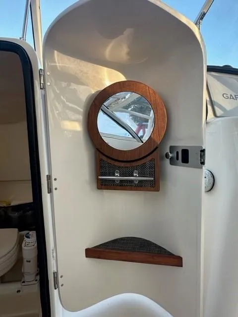 Slide: The Image of 2024 Grady-White 255 FREEDOM boat interior with mirror and storage. - 26