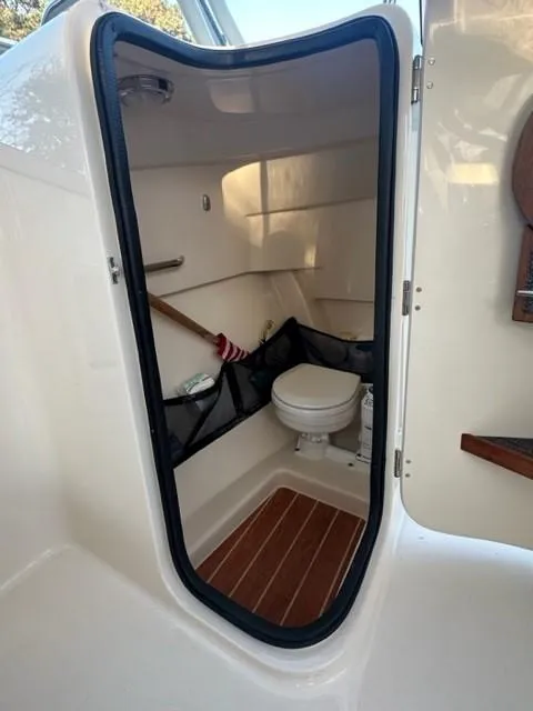 Slide: The Image of 2024 Grady-White 255 FREEDOM boat interior with compact bathroom and toilet. - 27