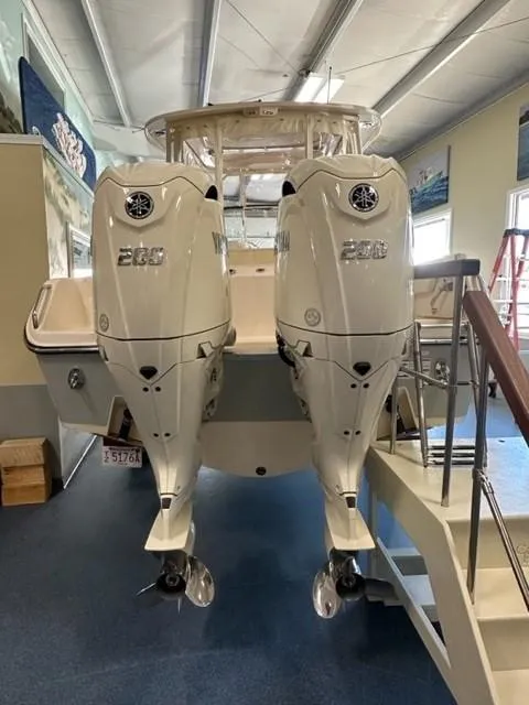 Slide: The Image of 2024 Grady-White 255 FREEDOM boat with dual outboard engines in showroom. - 3