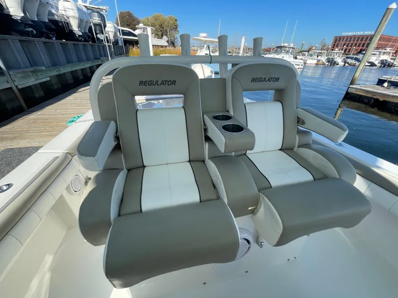 Slide: The Image of 2019 Regulator 34 boat seats at marina, featuring comfortable dual seating. - 11
