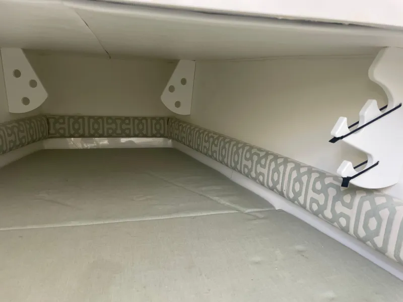 Slide: The Image of 2019 Regulator 34 boat interior with patterned cushions and storage space. - 12