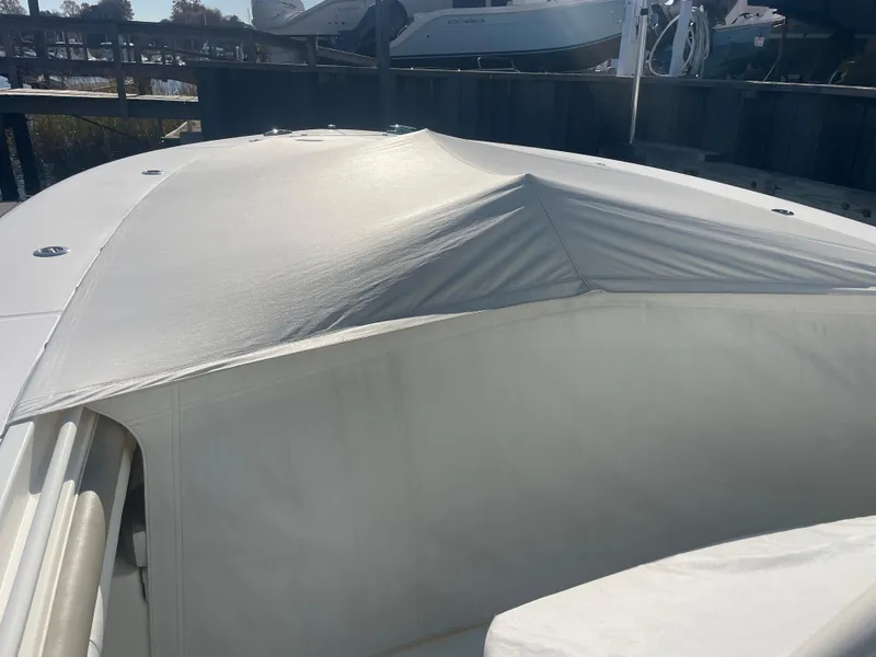 Slide: The Image of 2019 Regulator 34 boat with protective cover in marina setting. - 13