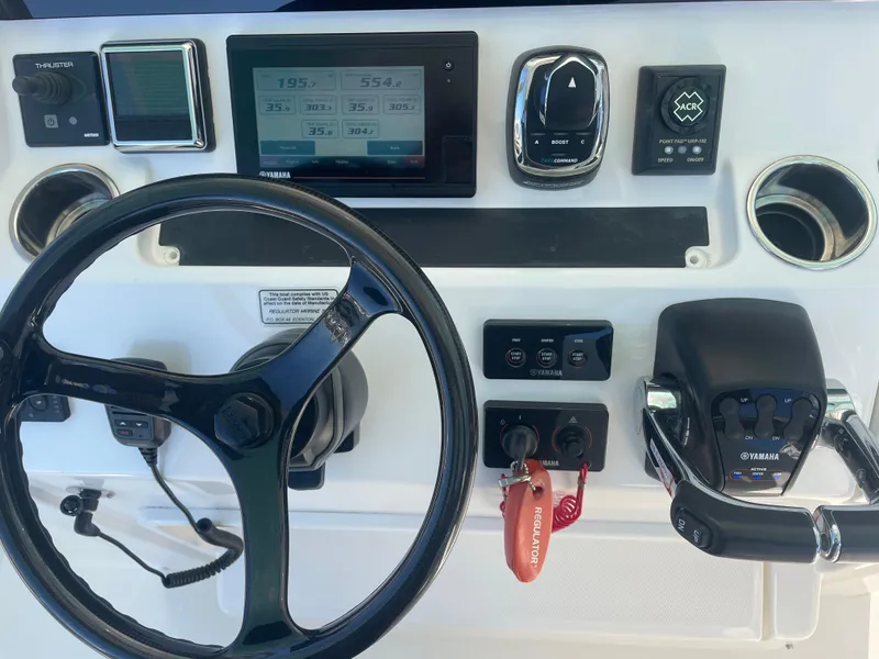Slide: The Image of 2019 Regulator 34 boat dashboard with steering wheel and control panel. - 16