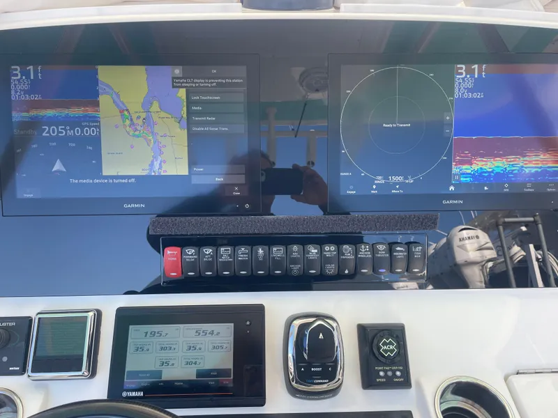 Slide: The Image of 2019 Regulator 34 boat dashboard with Garmin navigation displays and controls. - 17