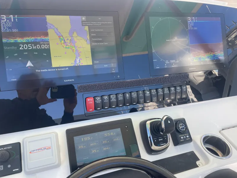 Slide: The Image of 2019 Regulator 34 boat dashboard with navigation screens and control panel. - 18