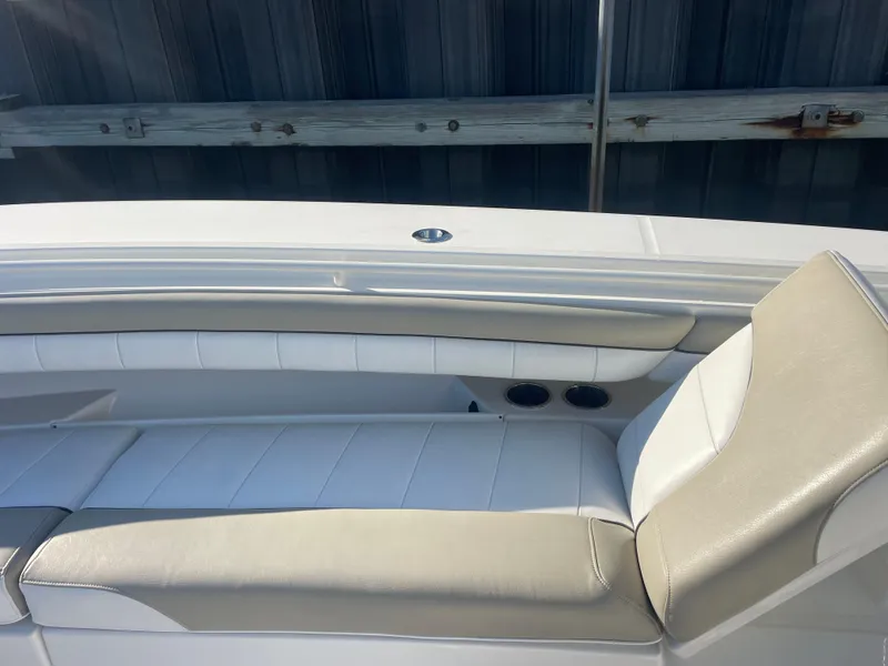 Slide: The Image of 2019 Regulator 34 boat interior with beige and white seating. - 19
