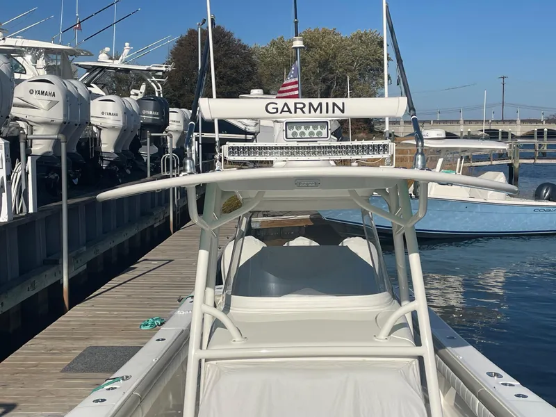 Slide: The Image of 2019 Regulator 34 boat docked, featuring Garmin equipment and Yamaha engines. - 23