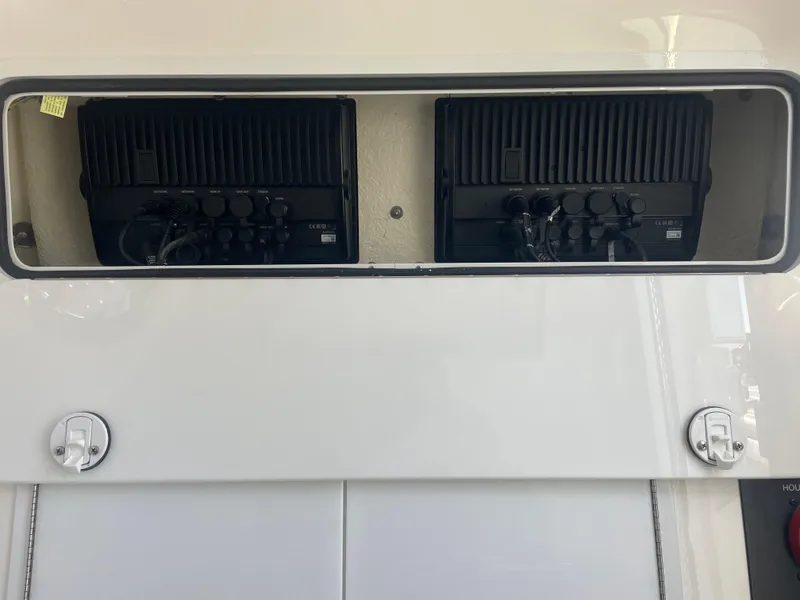 Slide: The Image of 2019 Regulator 34 boat electronics compartment with dual black control units. - 25