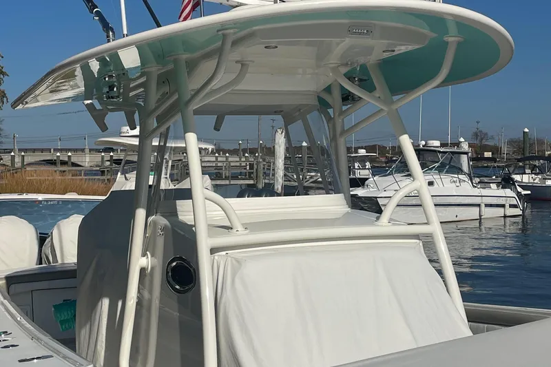 Slide: The Image of 2019 Regulator 34 boat with T-top, docked in a marina. - 26