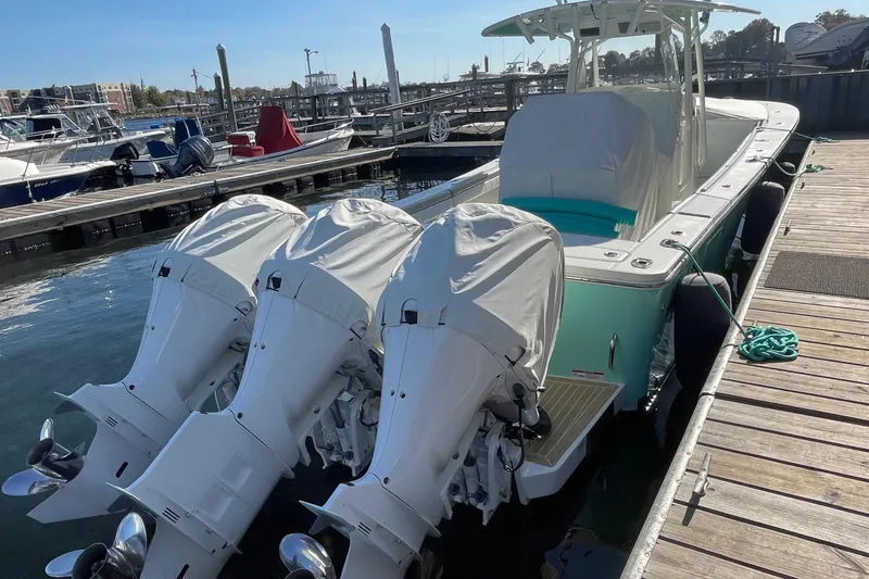 Slide: The Image of 2019 Regulator 34 boat with triple engines docked at marina. - 27