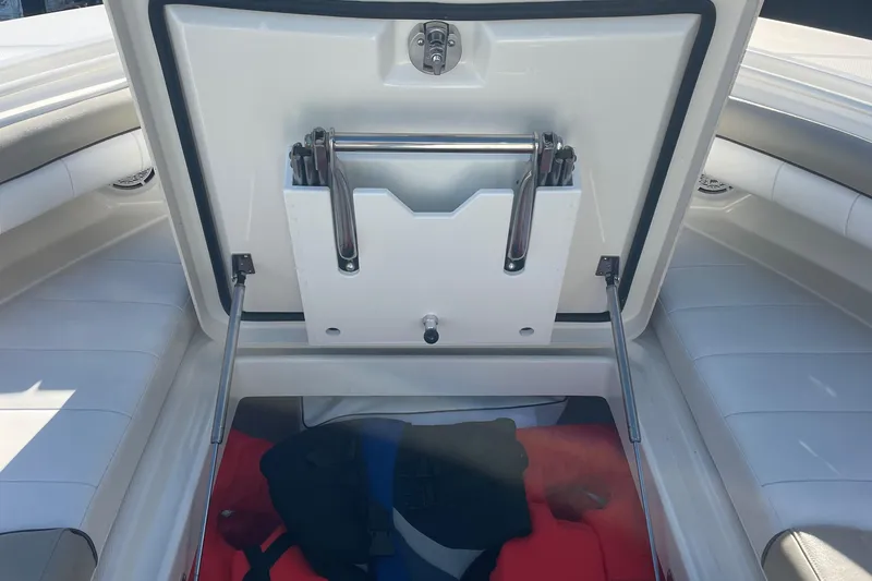 Slide: The Image of 2019 Regulator 34 boat storage compartment with open hatch and life jackets. - 34