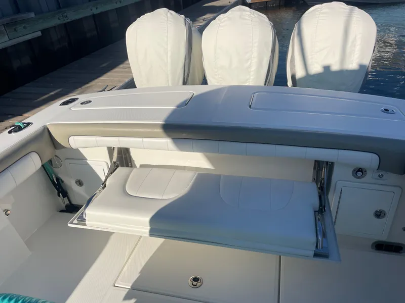 Slide: The Image of 2019 Regulator 34 boat with foldable seating and triple outboard engines. - 4