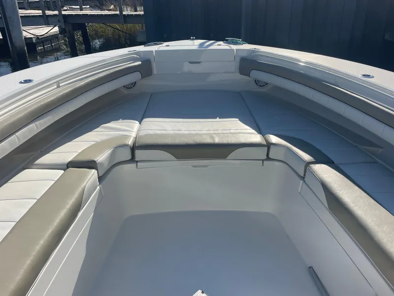 Slide: The Image of 2019 Regulator 34 boat interior with cushioned seating and sleek design. - 5
