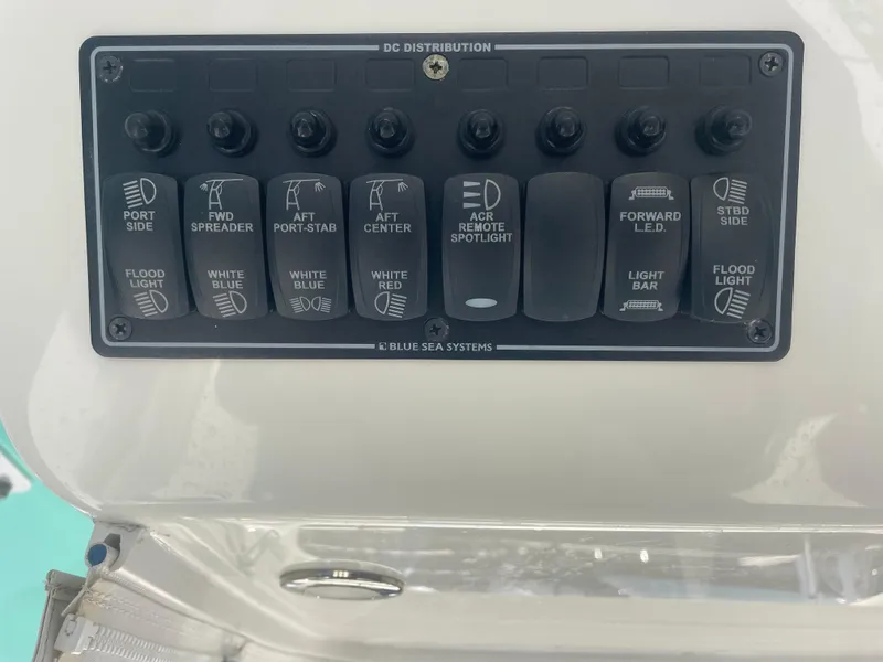 Slide: The Image of Control panel on a 2019 Regulator 34 boat with various light switches. - 6
