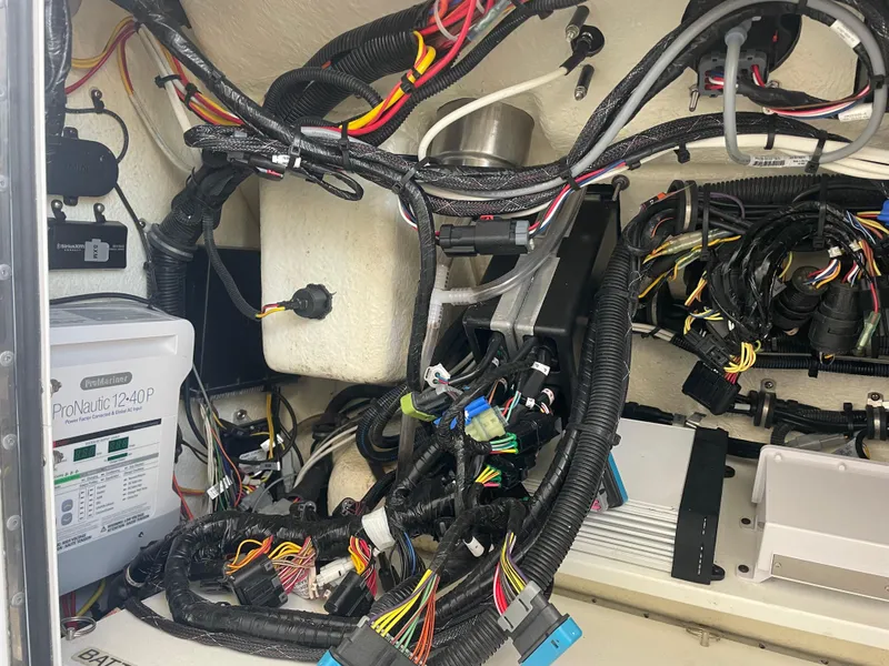 Slide: The Image of 2019 Regulator 34 boat wiring and electrical components in a compartment. - 7