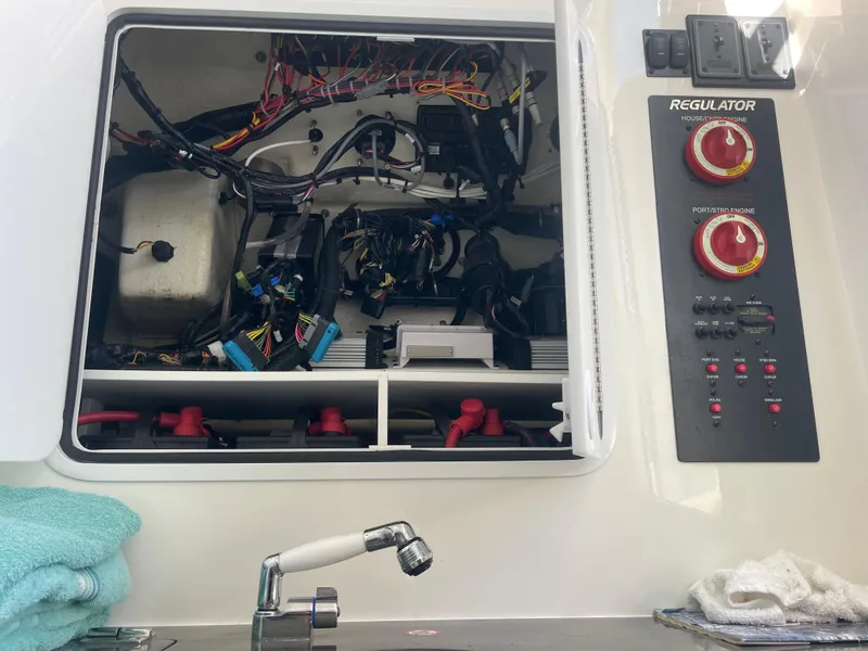 Slide: The Image of 2019 Regulator 34 boat electrical panel with wiring and control knobs. - 9
