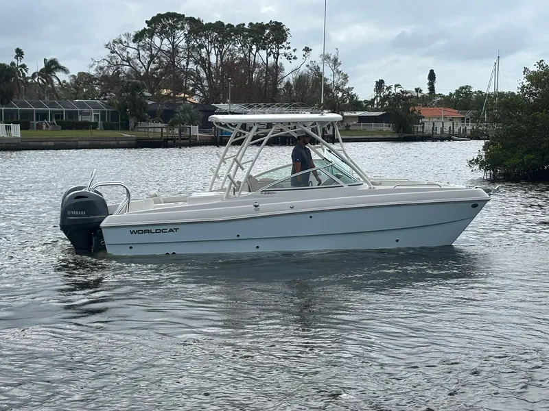 The Image of 2025 World Cat 230 SD boat on calm water, featuring sleek design and modern outboard motor. - 0