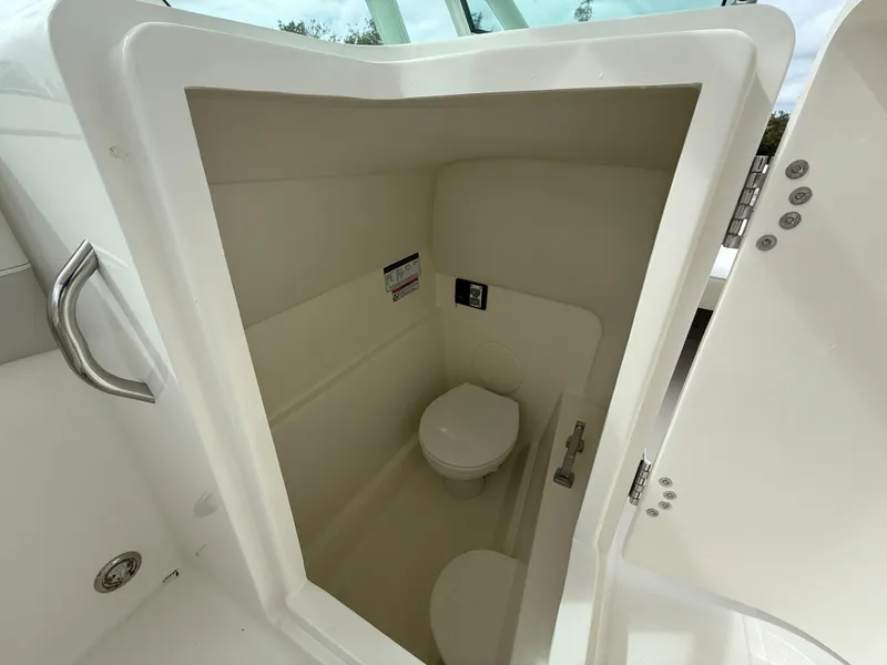 Slide: The Image of Compact marine toilet in 2025 World Cat 230 SD boat. - 10