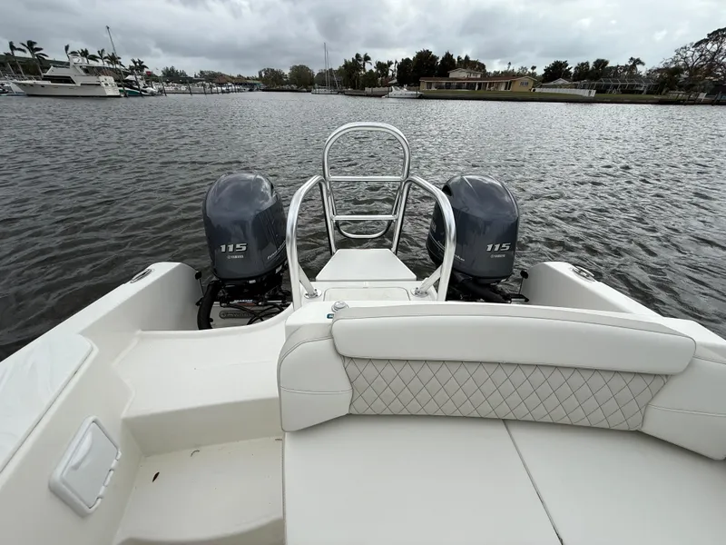 Slide: The Image of 2025 World Cat 230 SD boat with dual 115 engines on a calm waterway. - 6