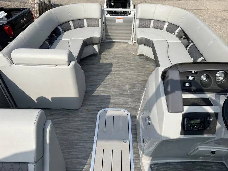 Slide: The Image of 2023 Bennington 22 L SB pontoon boat interior with spacious seating and modern dashboard. - 3