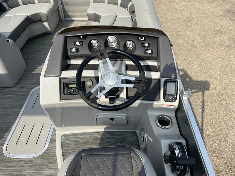 Slide: The Image of 2023 Bennington 22 L SB boat dashboard with steering wheel and controls. - 4