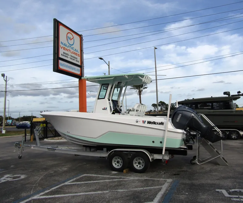 Slide: The Image of 2025 Wellcraft 223 Fisherman boat on trailer at Nautical Ventures dealership. - 1