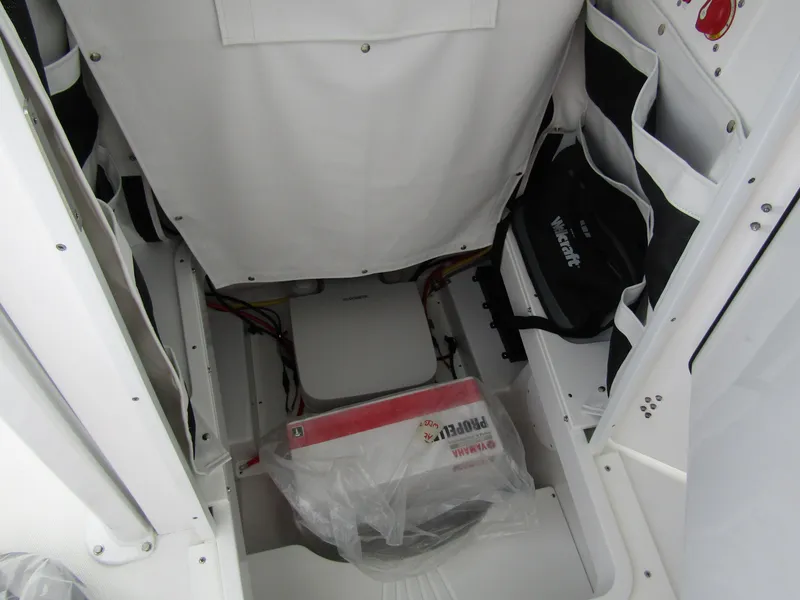 Slide: The Image of 2025 Wellcraft 223 Fisherman storage compartment with organized gear and equipment. - 11