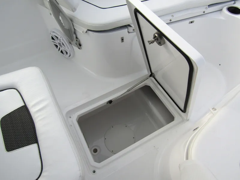 Slide: The Image of 2025 Wellcraft 223 Fisherman boat storage compartment open, showcasing interior space. - 13