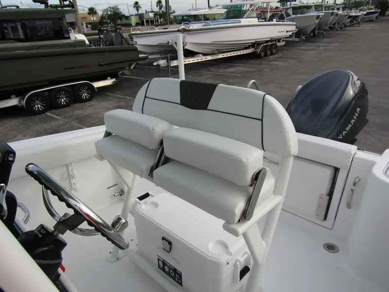 Slide: The Image of 2025 Wellcraft 223 Fisherman boat interior with dual seats and steering wheel. - 14