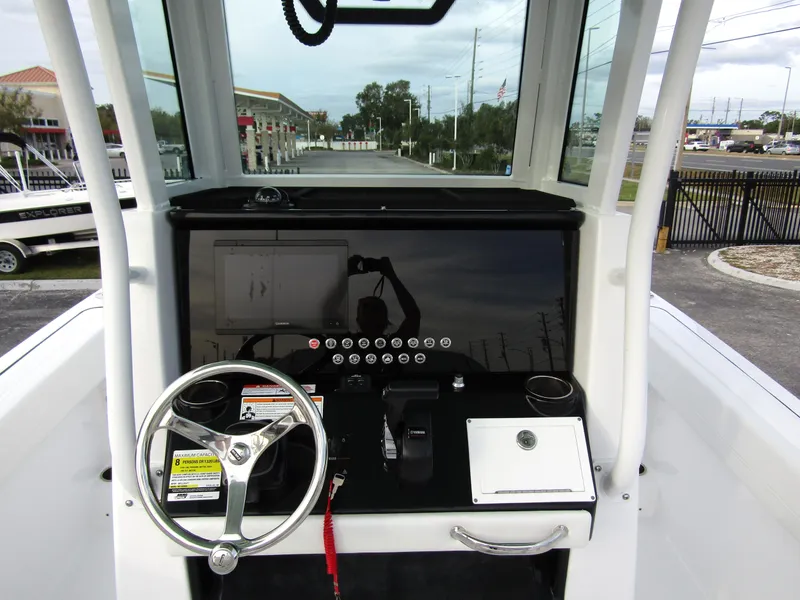 Slide: The Image of 2025 Wellcraft 223 Fisherman boat console with steering wheel and controls. - 15