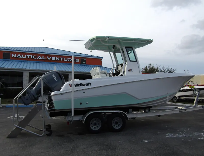 Slide: The Image of 2025 Wellcraft 223 Fisherman boat on trailer at Nautical Ventures dealership. - 2