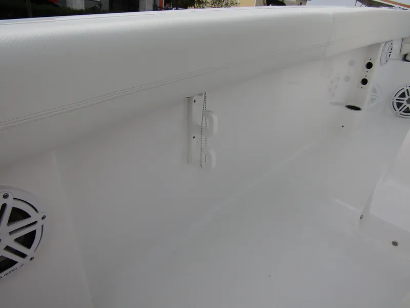 Slide: The Image of Interior view of 2025 Wellcraft 223 Fisherman boat, featuring white paneling and speaker. - 24