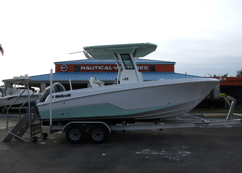 Slide: The Image of 2025 Wellcraft 223 Fisherman boat on trailer at dealership. - 3