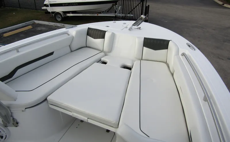 Slide: The Image of 2025 Wellcraft 223 Fisherman boat interior with white cushioned seating. - 7