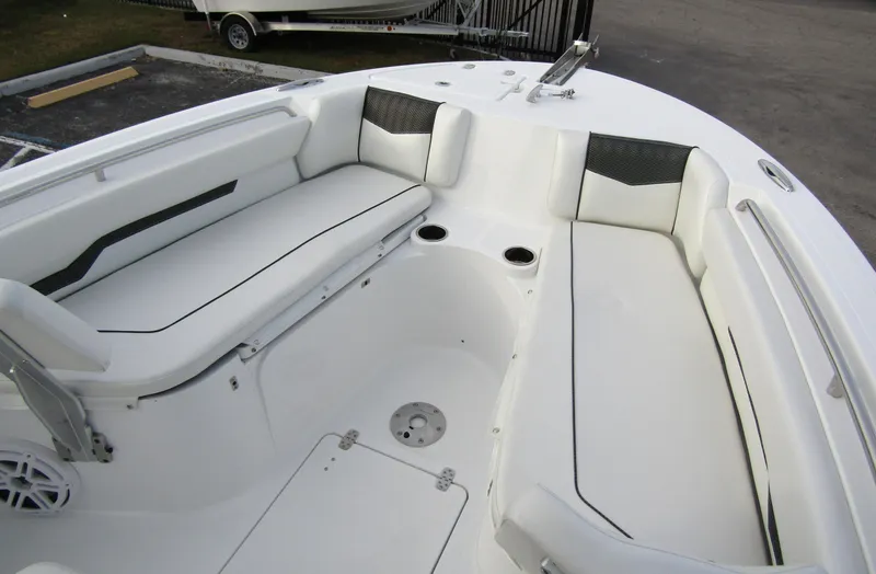 Slide: The Image of 2025 Wellcraft 223 Fisherman boat interior with white seating and cup holders. - 8