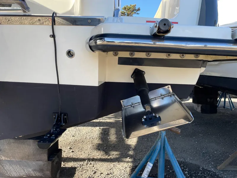 Slide: The Image of 2023 Scout 215 XSF boat stern with trim tab and outboard motor mount. - 4