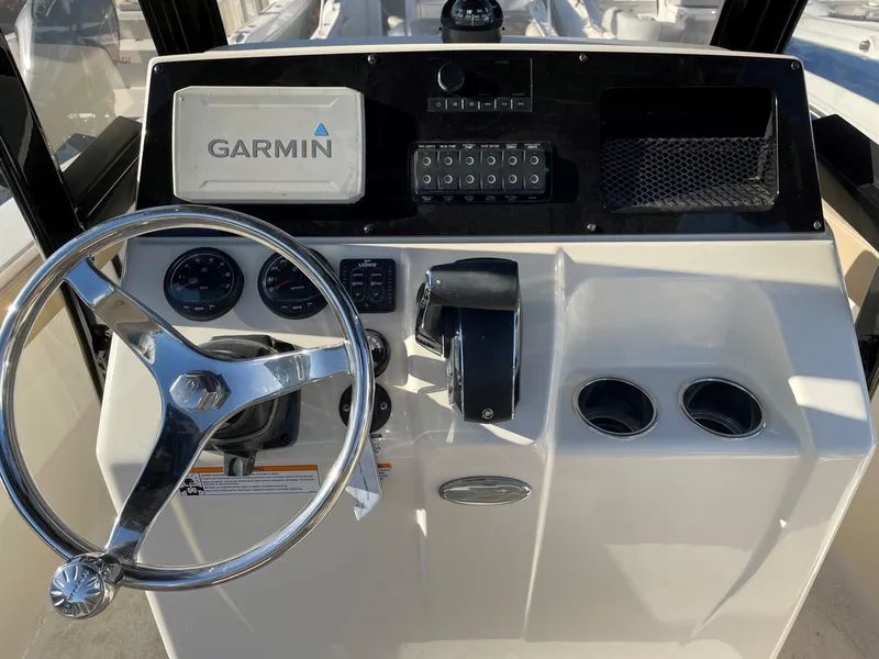 Slide: The Image of 2023 Scout 215 XSF boat dashboard with Garmin navigation system and steering wheel. - 5