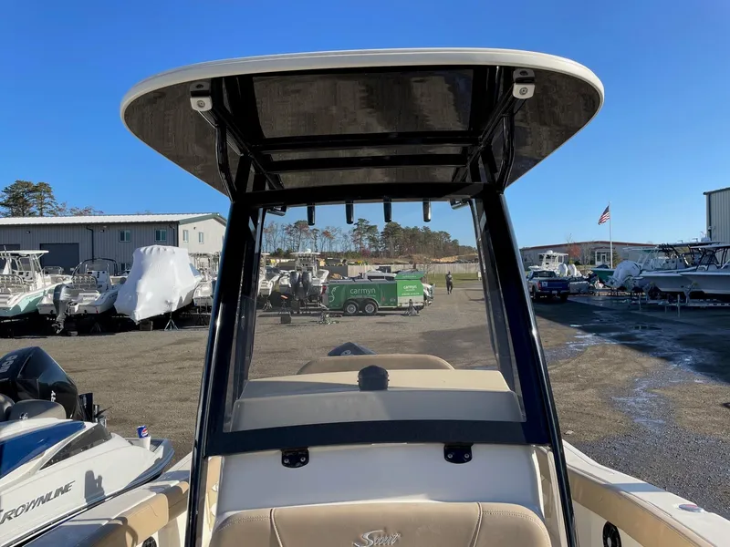 Slide: The Image of 2023 Scout 215 XSF boat at a marina with clear blue sky. - 6